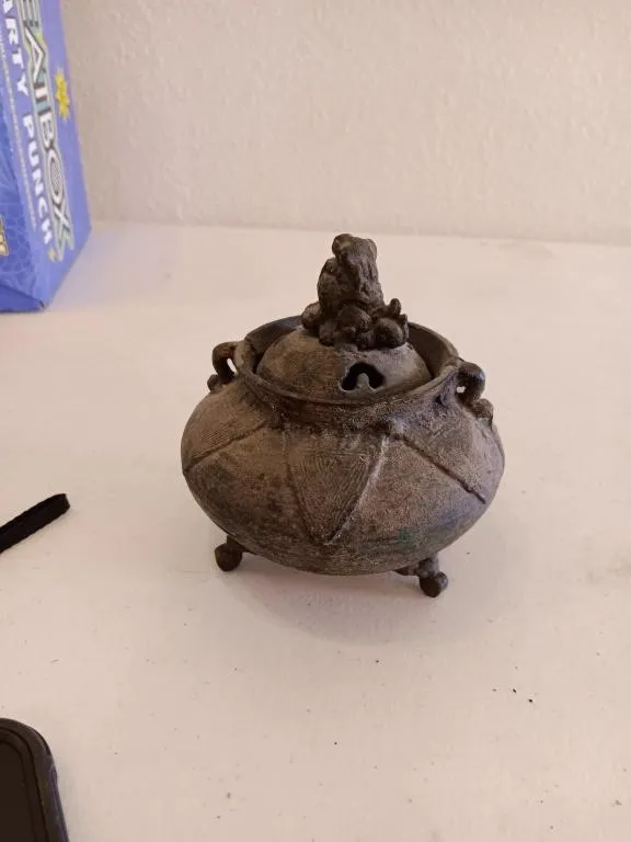 Decorative incense burner. Resembles bronze or
