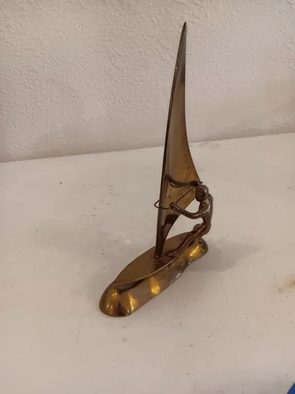 Vintage solid brass windsurfer sculpture.