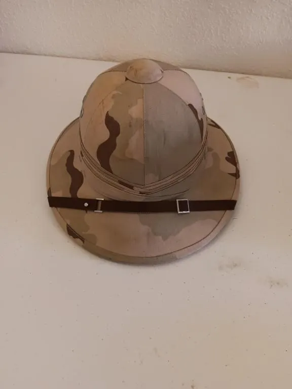 Desert camouflage pith military helmet.