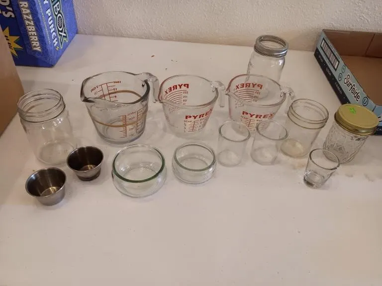 Pyrex measuring cups and assortment of glassware.