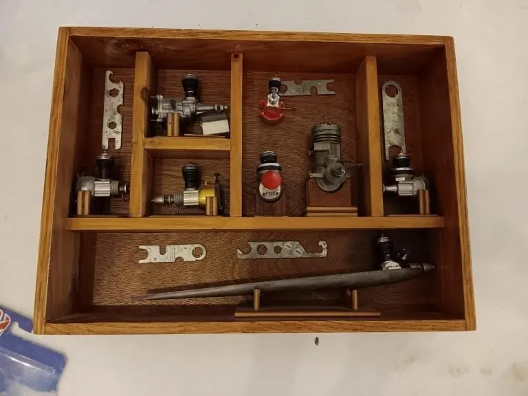 Model Airplane Engines mounted on wooden racking.