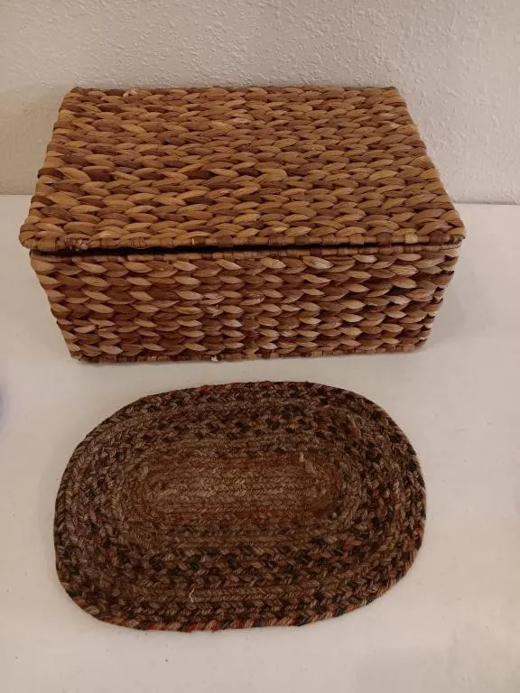 Storage box and oval braided placemat.