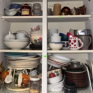 Cabinet Full of Assorted Kitchen Cups, Plates, Bowls, Mugs, and Storage Containers