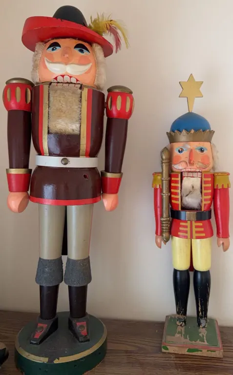 Wooden Nutcracker Figures with Painted Details and Feather Accent