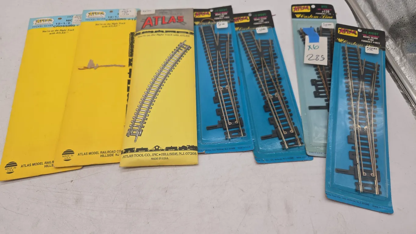 Assorted Atlas brand train track accessories, new and packages