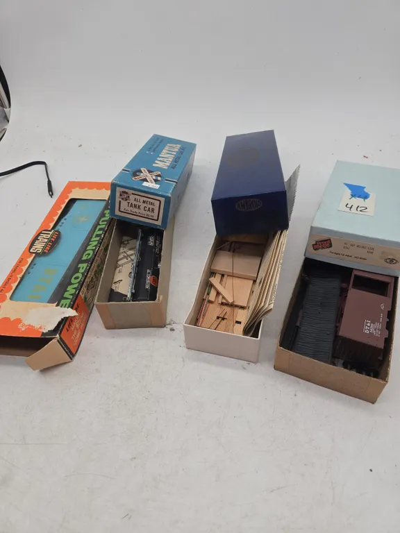 Assorted vintage HO scale train cars in original boxes