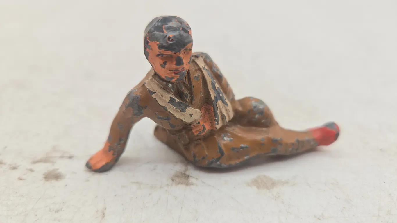 Antique lead man oil Barclay wounded soldier figurine