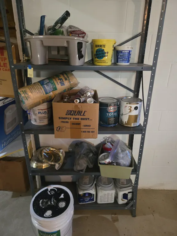 Assorted painting supplies and metal shelving unit