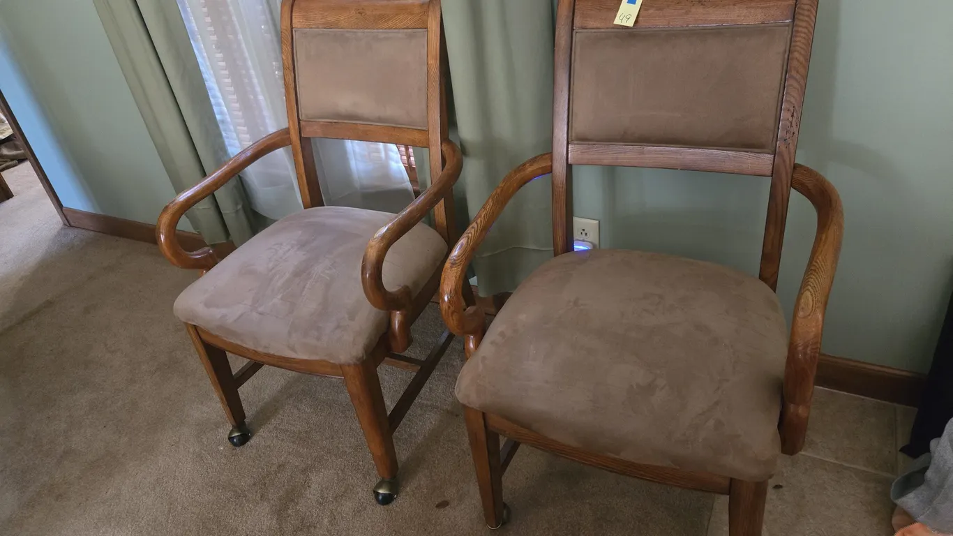 Pair of rolling padded armed dining chairs