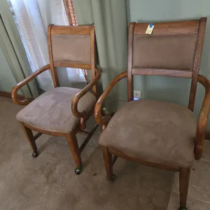 Pair of rolling padded armed dining chairs