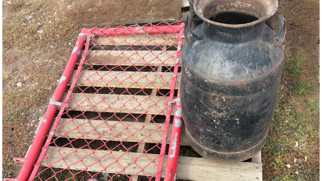 2 cream cans, red metal gate