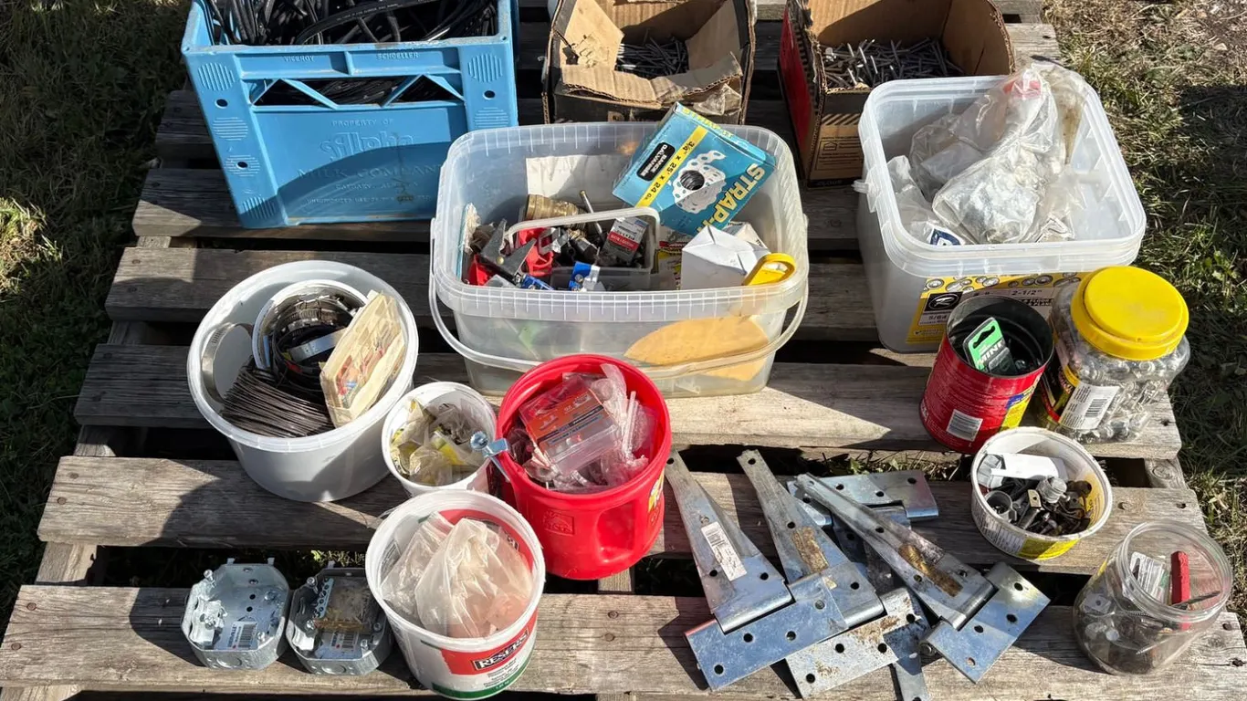 Pallet of misc screws, nails, door hinges, hay wire, misc parts