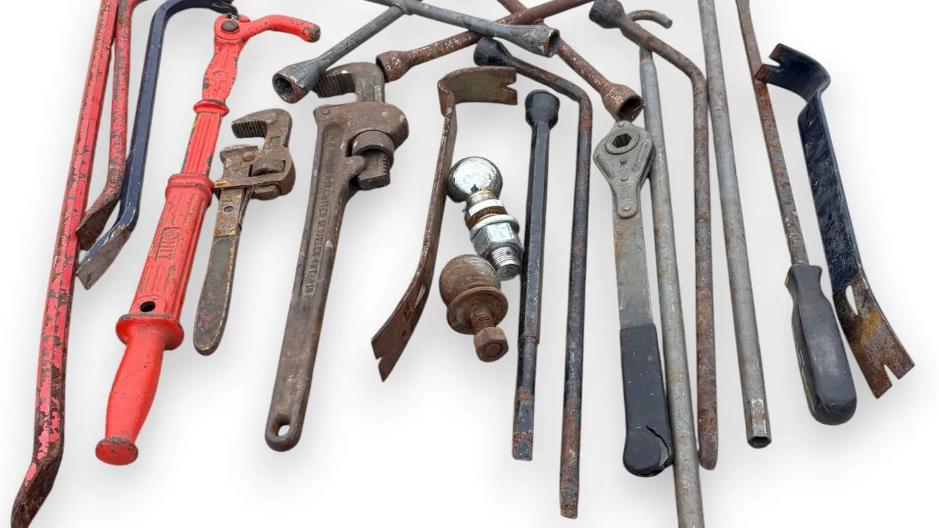 Assortment of Crow Bars, Pry Bars, Pipe Wrenches, Nail Puller, Wheel Wrench, Trailer Hitch Balls