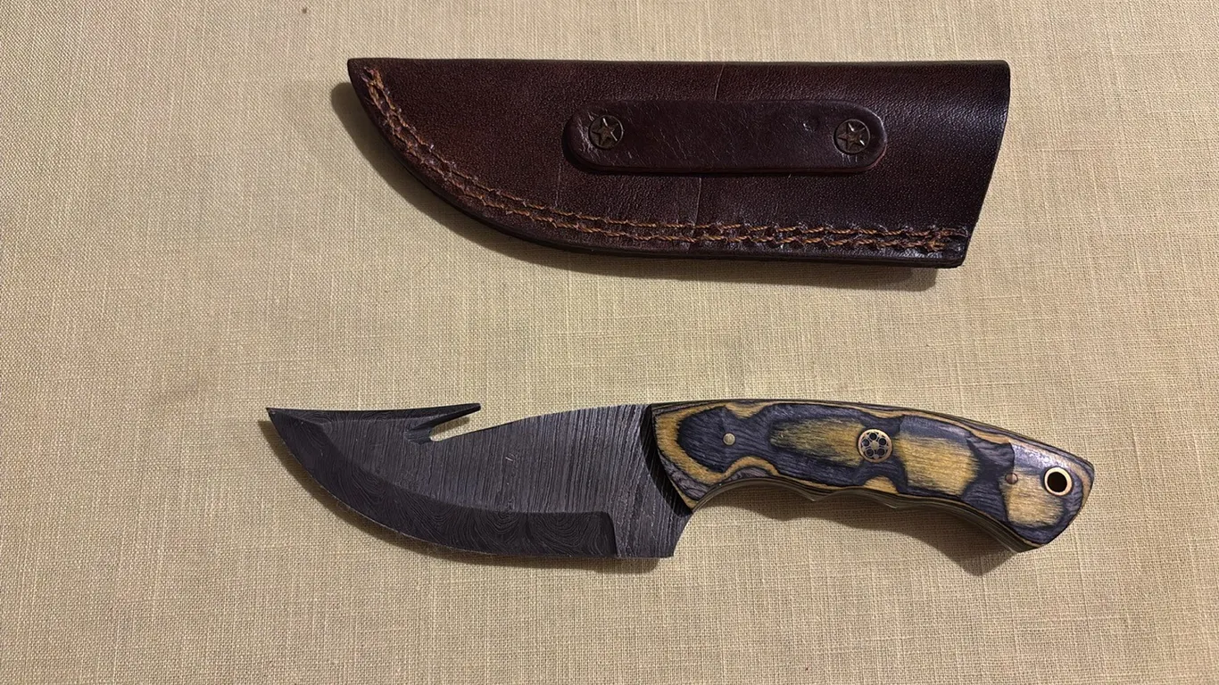 Damascus steel knife with gut hook