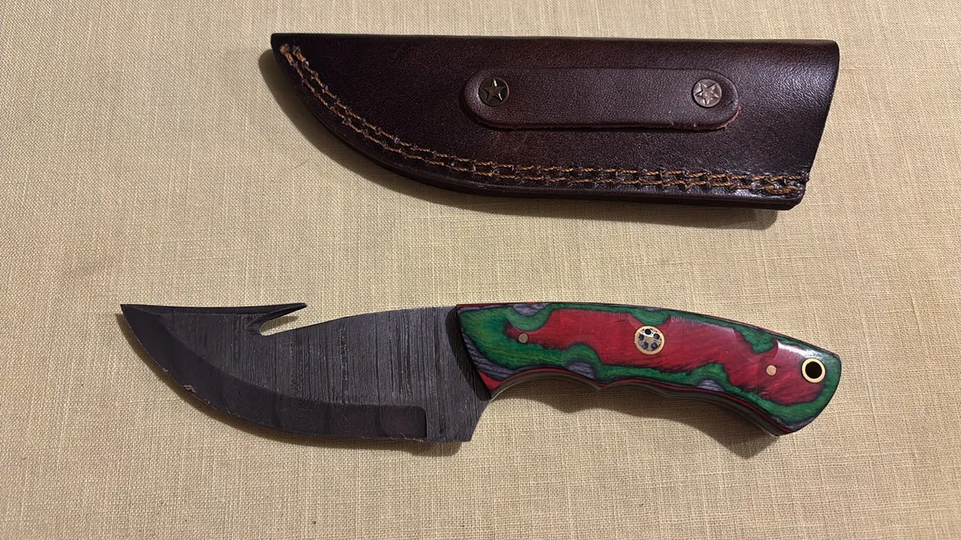Damascus steel knife with gut hook