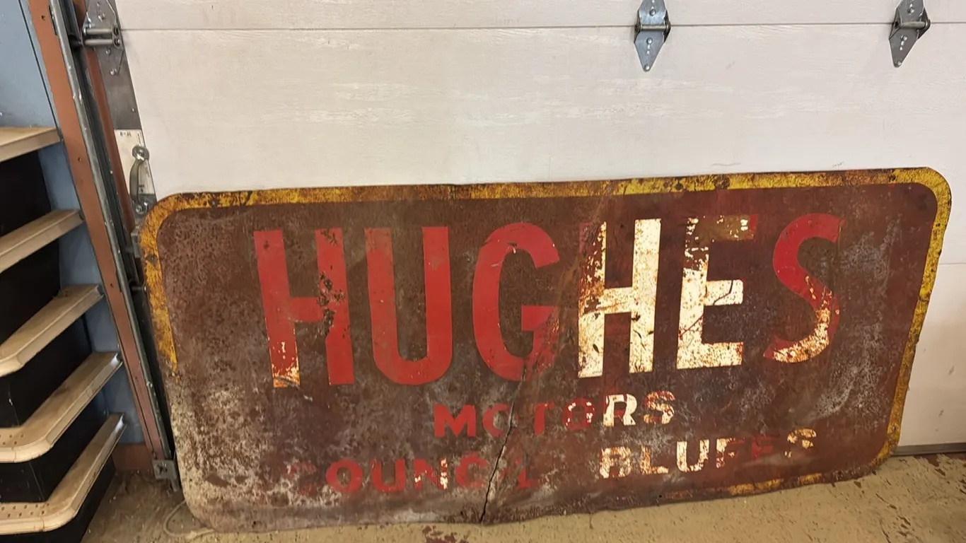 Hughes Motors metal sign