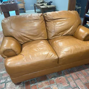 Caramel colored leather loveseat