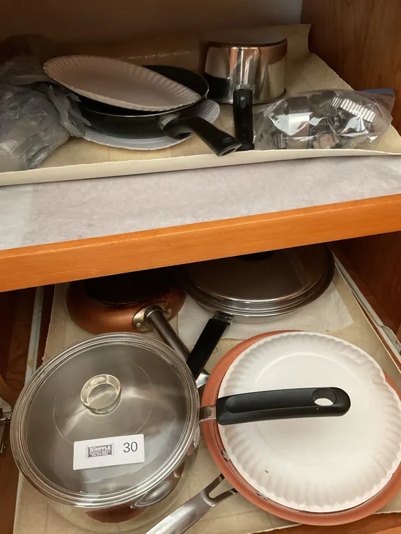 Bottom of stove & right cupboard pots & pans