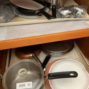 Bottom of stove & right cupboard pots & pans