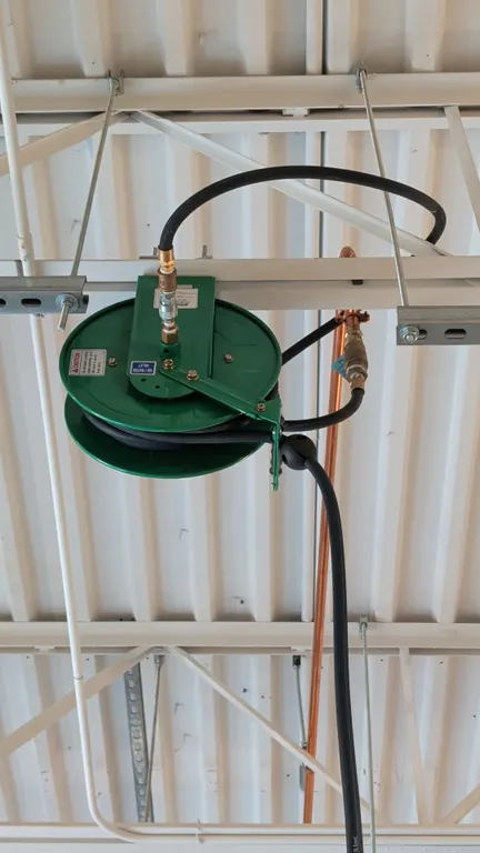 Speedaire retractable air hose reel. Buyer responsible for removal