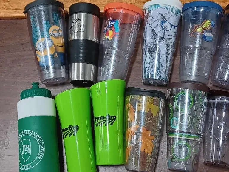 Assortment of cups and water bottles. Eighteen in