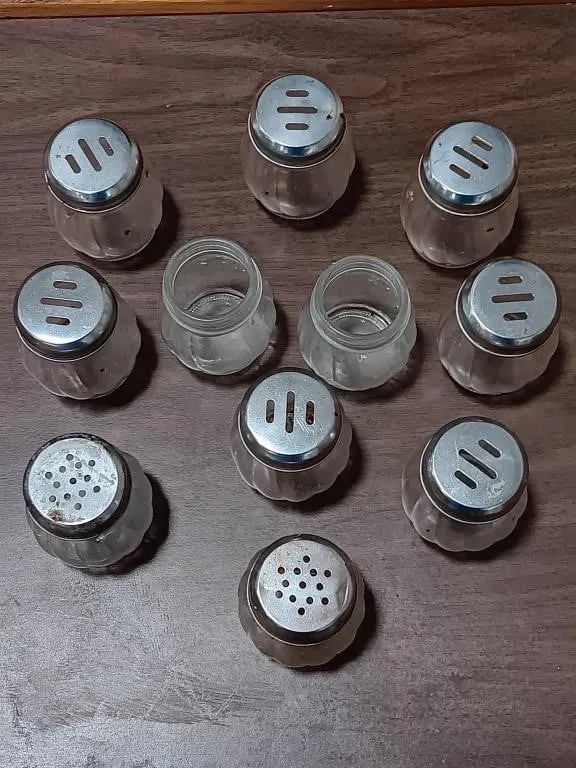 Set of seasoning dispensers, used. Nine are