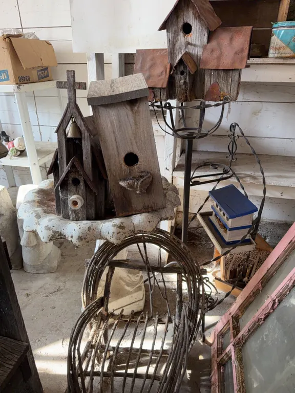 Rustic Wooden Birdhouses, Willow Chair, Concrete birdbath and plant stand.