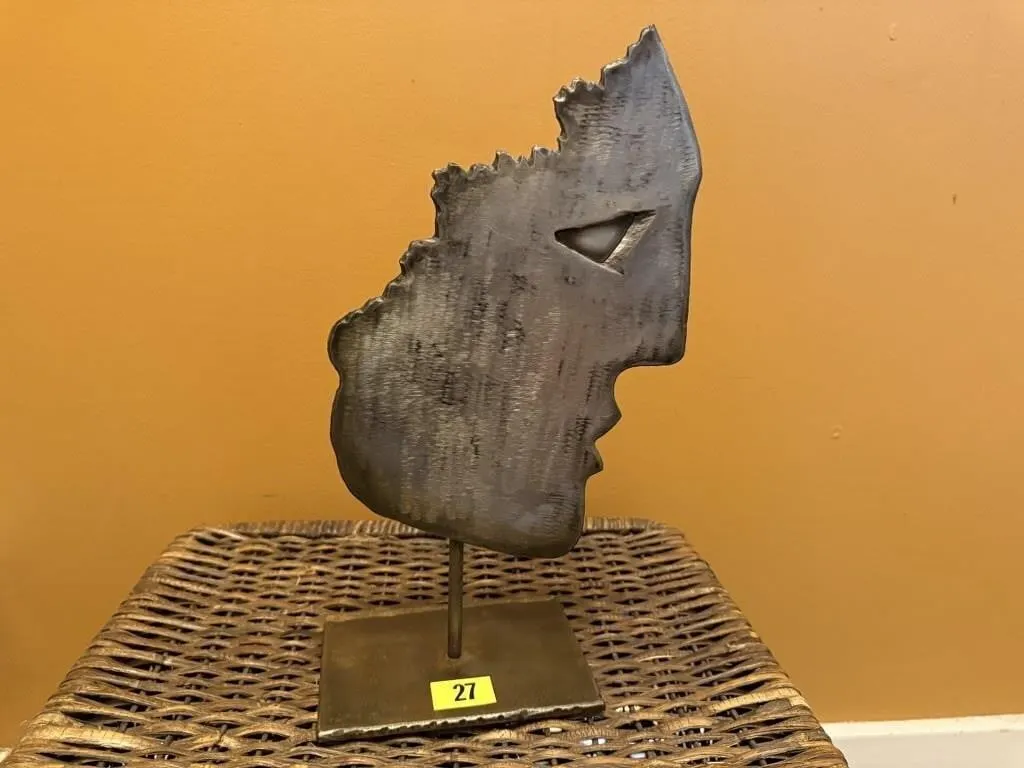 Metal face sculpture
