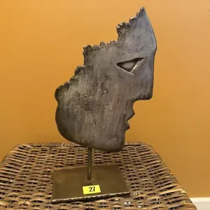 Metal face sculpture