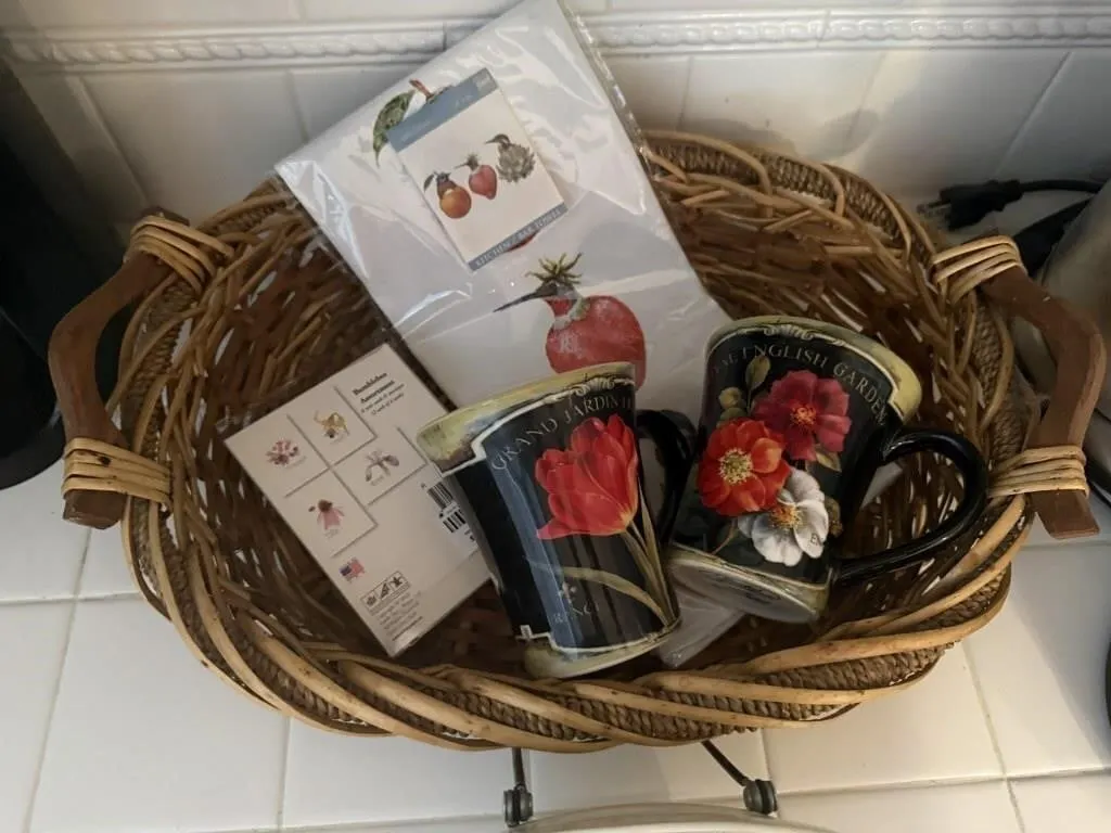 Basket, mugs, china plate, cards, dish towel