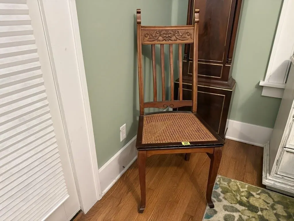 Caned seat carved back dining chair
