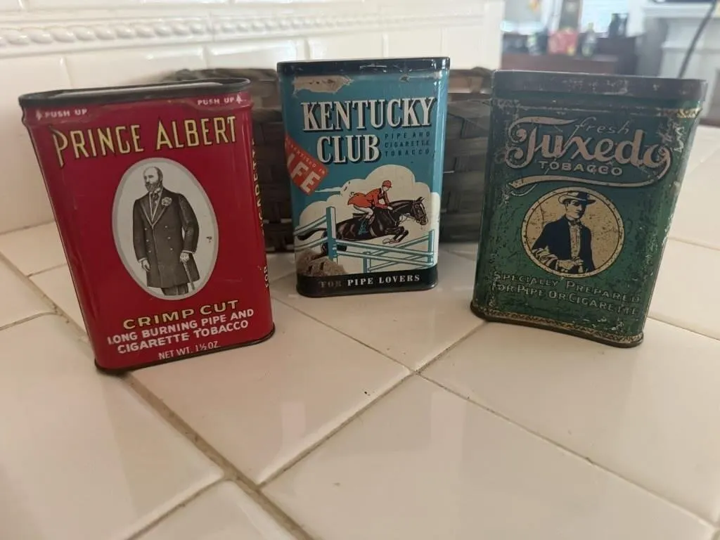 Basket of tobacco tins, tie clip