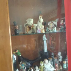 (8) Shelves of Small Figurines in Wall Cabinet