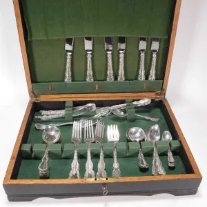 Boxed set of Louis XV sterling silver flatware including six dinner knives, ten dinner forks, six de