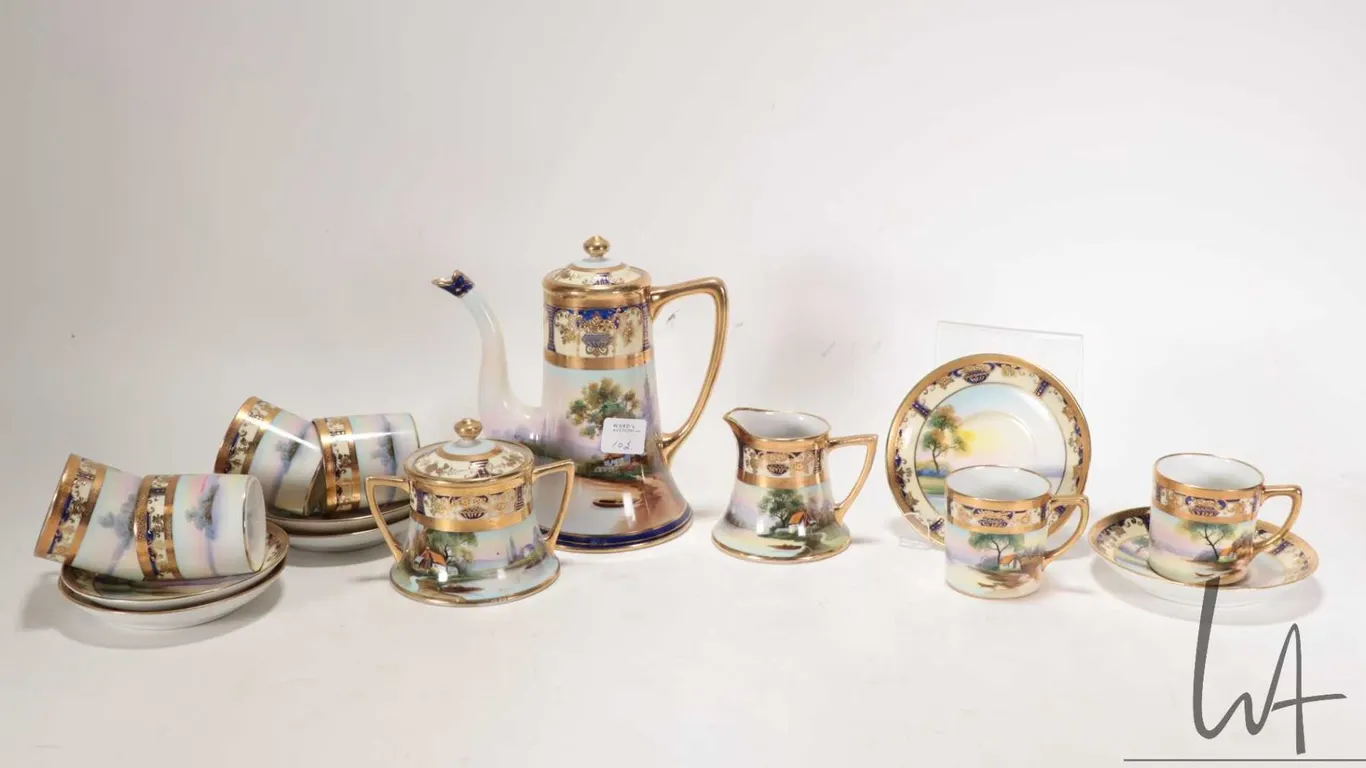 Antique hand-painted Noritake coffee service with scenic landscape panels and heavy gold gilding. In
