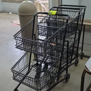 2-tier metal shopping carts. Features black wire construction with upper and lower baskets, handle grip, and nesting design. Mounted on casters.