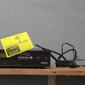 Mood ProFusion iS 2010 commercial digital media player. Features front LCD screen, optical disc drive, front panel navigation buttons, and rear connec