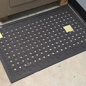 Rubber floor mat. Features perforated drainage holes, textured non-slip tread, and beveled safety edges. 36" x 24".