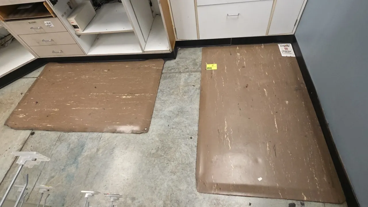 Rubber anti-fatigue mats. Features brown marble-pattern surface with beveled edges. 60" x 36" each. Note: Edges show tears.