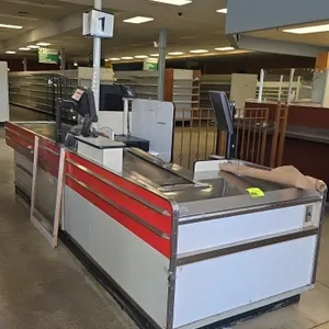 Borroughs Series 80 dual belt checklane. Features motorized front and rear conveyor belts, integrated scanner well, lane number light pole, cashier st
