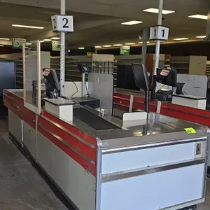 Borroughs Series 80 dual belt checklane. Features dual conveyor belts, stainless steel decking, cashier station with undercounter storage shelving, la