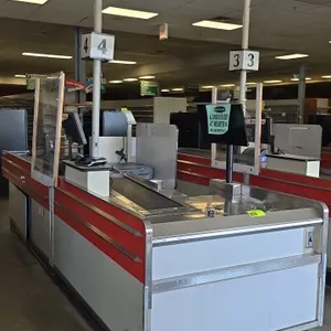 Borroughs Series 80 dual belt checklane. Features stainless steel trim, dual conveyor belts, acrylic protective shield, lane light pole, and lower sto