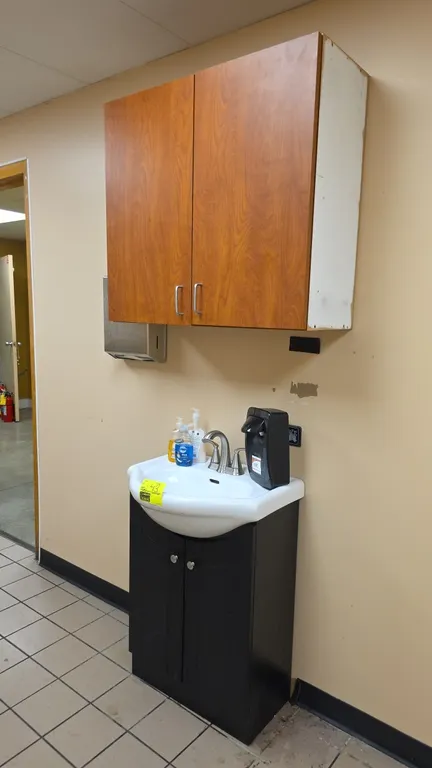 Bathroom vanity set with sink and upper cabinet. Includes 24" x 20" ceramic sink with dual-handle faucet, dark laminate 2-door vanity base, 2-door upp