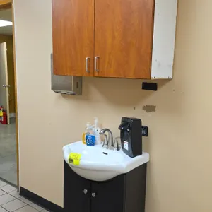 Bathroom vanity set with sink and upper cabinet. Includes 24" x 20" ceramic sink with dual-handle faucet, dark laminate 2-door vanity base, 2-door upp