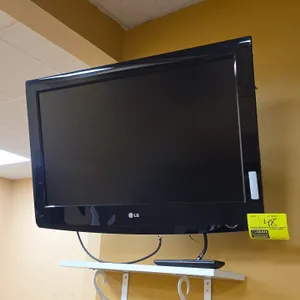 LG 32" flat screen TV. Includes remote control and wall mounting bracket.