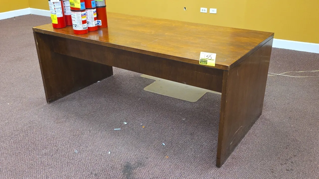 Solid wood desk. Features a center pull-out drawer, modesty panel, and slab end base. Includes polycarbonate floor mat. 72"L. Fire extinguishers not i