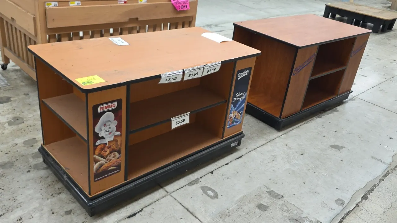 Portable laminate wood 4-sided merchandisers. Features woodgrain laminate finish, center shelving, open end display compartments, and black edge bandi