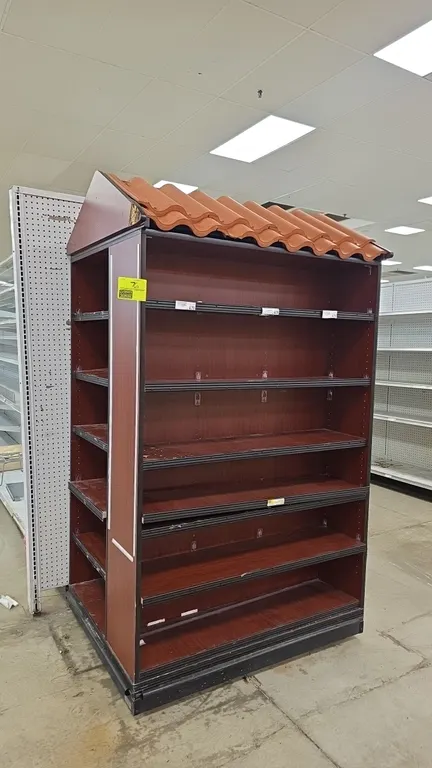 Laminate wood 3-sided display merchandiser. Features faux Spanish tile roof canopy, cherry woodgrain finish, multi-tier shelving with price tag moldin