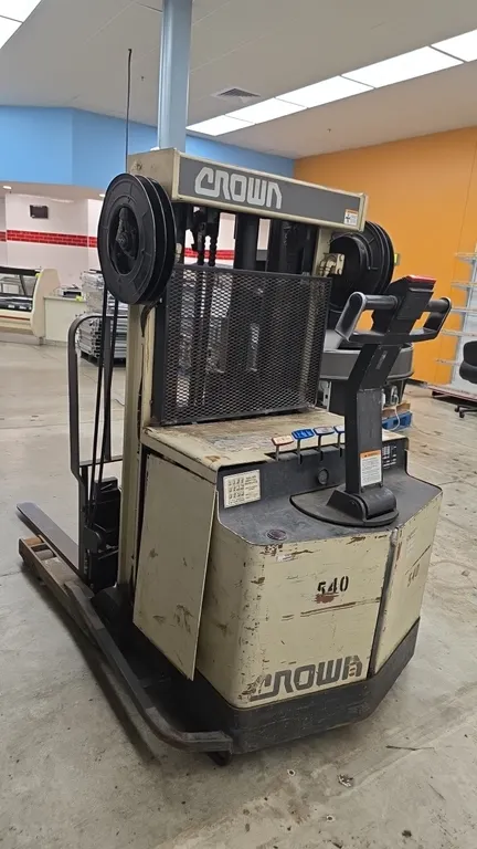 Crown 30WRTT electric walkie reach stacker. Features 3,000 lb capacity, 152" maximum lift height, 3-stage mast, 42" forks, load backrest, and control