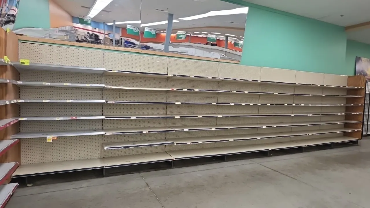 28'L of Lozier wall shelving with 32" x 66" end merchandiser. Features 80"H uprights, 19"D base shelves, adjustable upper shelves, and pegboard backin
